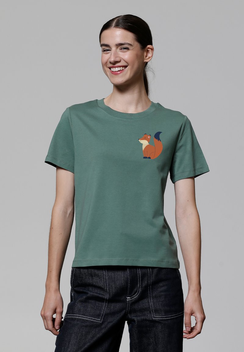 Grünes Baumwoll-T-Shirt mit Rundhalsausschnitt und kurzen Ärmeln. Auf der linken Brust befindet sich ein Fuchs-Motiv in Orange und Blau.