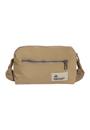 Beige rechthoekige crossbodytas met voorvak met ritssluiting en verstelbare riem, met een klein wit logo-patch aan de voorkant.