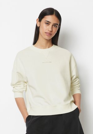 Helle beige Sweatshirt mit rundem Halsausschnitt und gerippten Bündchen. Verfügt über eine dezente Markenkennzeichnung auf der Brust und einen lässigen Schnitt.