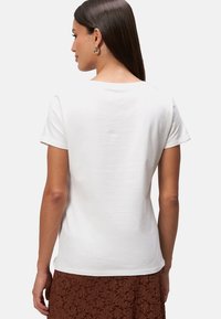 T-shirt blanc à manches courtes avec une coupe décontractée, fabriqué en coton doux, doté d'un col rond et d'une texture lisse.