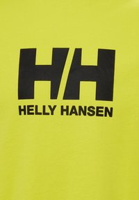 Světlě žluté tričko s velkým černým nápisem "HH" a "HELLEY HANSEN". Vyrobeno z hladké, lehké tkaniny, vhodné pro každodenní nošení.