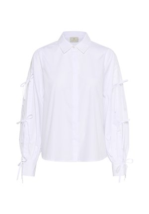 Blusa bianca in cotone con chiusura a bottoni, colletto classico e maniche lunghe con lacci regolabili ai polsini.