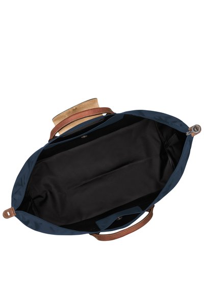 Blue tote bag with brown leather straps, open to reveal a black interior. Features a smooth texture and a snap closure inner pocket.