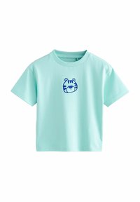 T-shirt vert menthe à manches courtes en coton, avec un graphique de visage de tigre bleu sur la poitrine. Design à col rond avec une coupe décontractée.