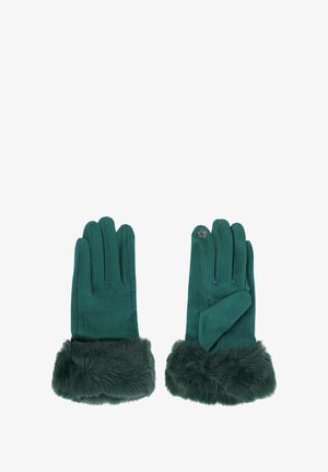 Guanti in ecopelle scamosciata verde con polsini in pelliccia. Quattro dita allungate e una forma leggermente affusolata. Presentano un piccolo distintivo decorativo su un guanto.