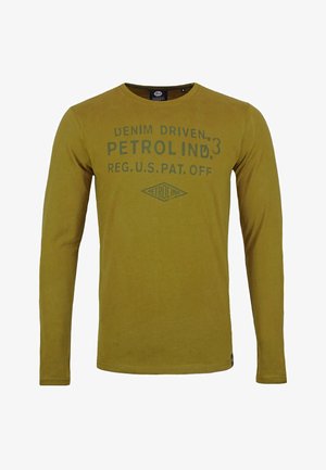 Langärmliges Senfgelb-Shirt mit Rundhalsausschnitt. Vorderseite mit grünem Drucktext und diamantförmigem Logo. Weicher, leichter Stoff.