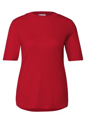 T-shirt rouge à manches courtes avec un col rond, fabriqué en tissu doux, présentant une coupe décontractée et un ourlet légèrement plus long à l'arrière.