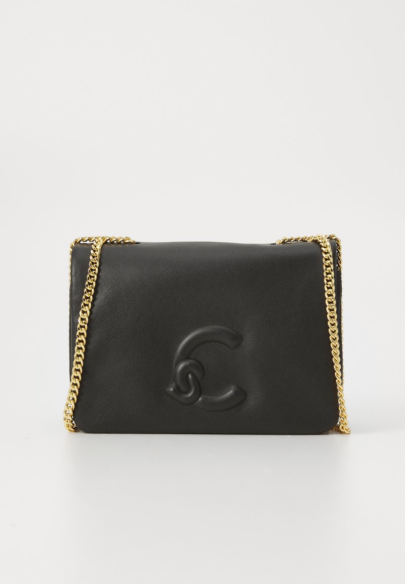 Black leather handbag with a raised logo, featuring a gold chain strap and a smooth texture. Compact rectangular shape with minimal detailing.