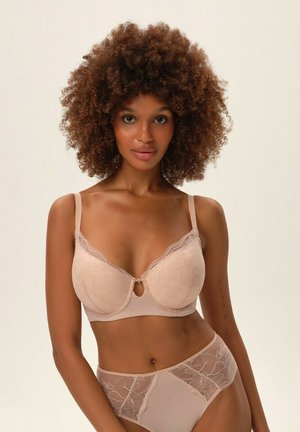 Light beige bra and matching high-waisted briefs featuring floral lace accents and a keyhole detail at the center, smooth texture.