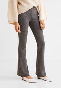 Gray flared pants with a checked pattern, made of a smooth fabric, featuring a mid-rise waist and fitted through the thighs.