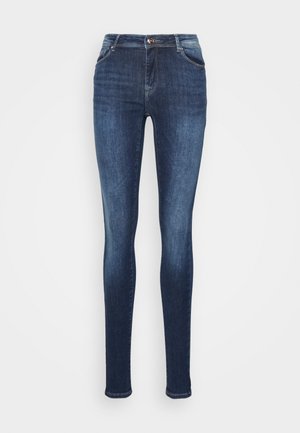 Jeans ajustados feitos de denim azul escuro, apresentando bolsos frontais, fecho de correr e um design justo com uma textura suave.