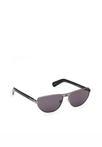 Gafas de sol aviador de metal negro con lentes oscuras y patillas de plástico, con el logo de Adidas en las patillas y el puente.