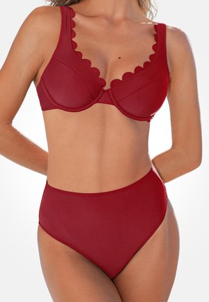 Conjunto de bikini rojo con diseño de borde festoneado en el sujetador y parte inferior de tiro alto en color rojo sólido. Textura suave, con accesorios mínimos.