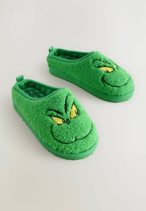 Zöld fleece papucs Grincs arcképpel, sárga szemekkel, mosollyal és gumitalppal a biztos tapadásért. Csúsztatható stílus hátul fülekkel.