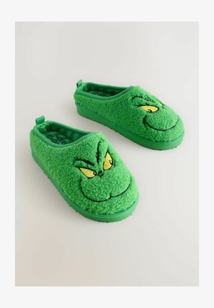 Zöld fleece papucs Grincs arcképpel, sárga szemekkel, mosollyal és gumitalppal a biztos tapadásért. Csúsztatható stílus hátul fülekkel.