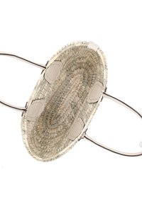 Woven straw basket with light beige and cream tones, oval shape, two handles, and circular textured accents on the base.