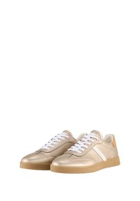 Gold leather sneakers with a white stripe, round toes, and white laces. Textured rubber sole and tan heel accent. Minimalist design.