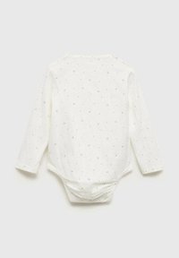 Bodysuit blanc à manches longues avec un col rond, présentant de petits motifs en pointillés noirs, en tissu doux, et des fermetures à pression au dos et au bas.