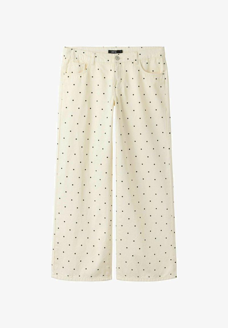 Pantalon large crème à pois noirs, bouton devant, fermeture éclair, passants de ceinture et deux poches avant.