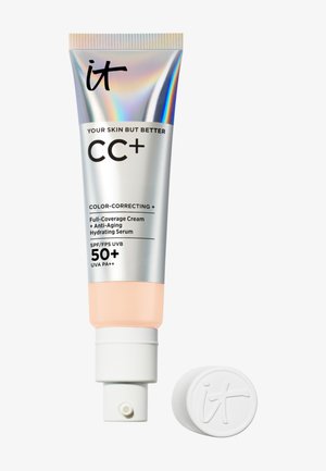 Tube argenté de crème correctrice de couleur à couvrance totale IT Cosmetics CC+ avec SPF 50+ et bouchon blanc placé à côté.
