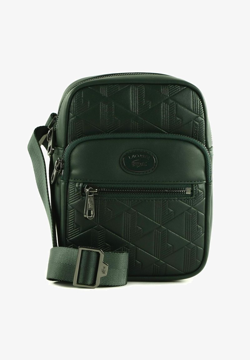 Zielona torebka crossbody z teksturowanej skóry, ozdobiona geometrycznym wzorem, z regulowanym paskiem, przednią kieszenią na zamek i akcentem z logo.