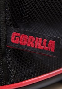 Black mesh bag with a red and black “GORILLA” label, featuring a zip closure and red accents along the edges. Textured exterior.