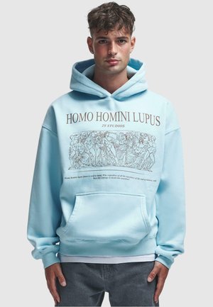 Light blue hoodie featuring a graphic print in brown. It has a kangaroo pocket and a drawstring hood. Soft fabric with a relaxed fit.