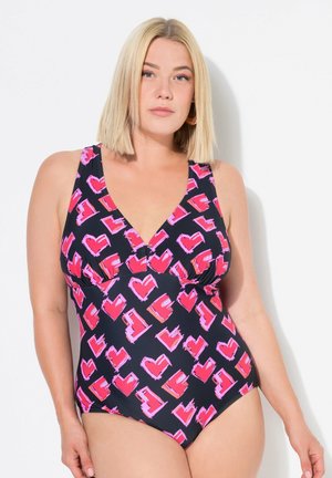 Costume intero con sfondo blu navy e un motivo di cuori rosa e rossi. Il design include un collo a V e spalline.