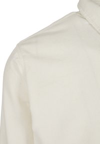 Light beige corduroy shirt with a textured ribbed surface, featuring a classic collar and a clean finish. No visible hardware or embellishments.