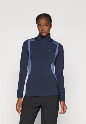 Marineblauwe longsleeve pullover met half-zip en lichtblauwe accenten, gemaakt van een gladde, rekbare stof. Heeft een hoge kraag en een slim fit ontwerp.