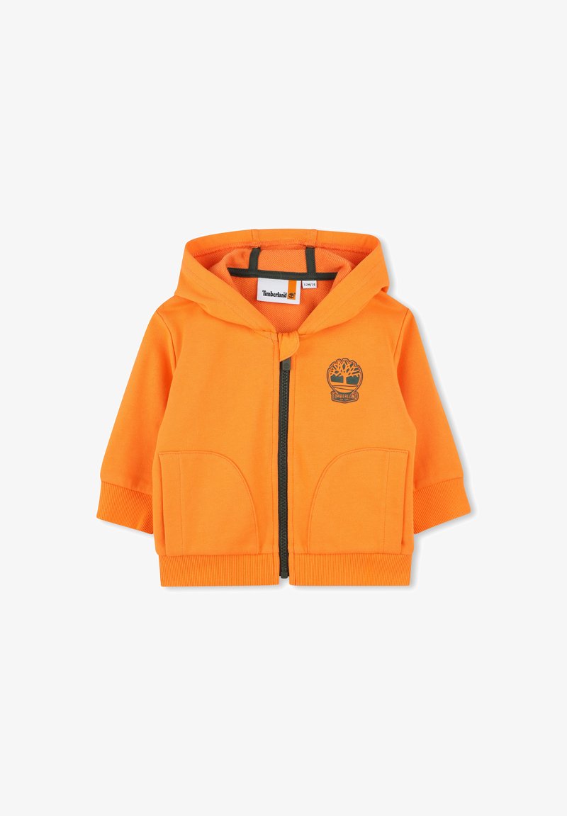Felpa arancione con cappuccio in cotone, dotata di zip frontale, due ampie tasche, polsini a costine e logo Timberland sul petto.