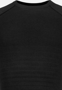 Black long-sleeve top made of textured fabric, featuring a crew neck and seamless shoulder design, emphasizing a smooth, fitted appearance.