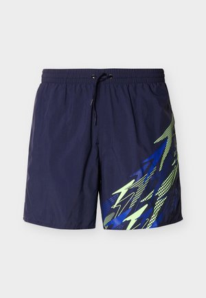 Meresinine ujumispüksid elastse vöökohaga ja musta paelaga, millel on parema jala küljes sinise ja kollase abstraktse välgulöögi kujundus.