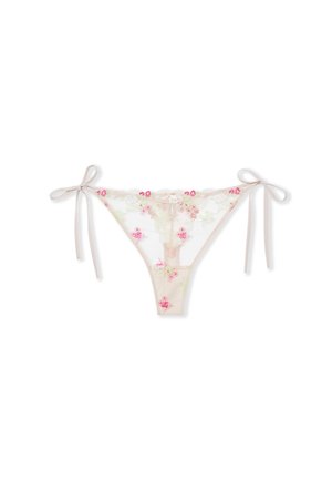 Culotte bikini beige transparente avec broderies florales roses et vertes, et nœuds à nouer sur les côtés, sur fond blanc.