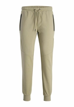 Khaki joggery z elastycznym pasem, związywaniem i dwiema bocznymi kieszeniami na zamek. Wykonane z miękkiego, gładkiego materiału z tapered leg.
