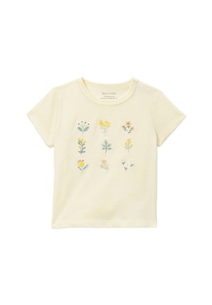 T-shirt crème à manches courtes pour tout-petit avec neuf petites fleurs brodées disposées en trois rangées sur le devant.