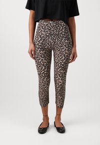 Leopard print leggings made of soft fabric, fitted, with a capri length, featuring a black waistband and leg openings.