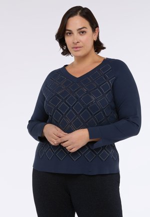 Granatowy sweter z dekoltem w serek i długimi rękawami. Posiada wzór w romby z wycięciami oraz małymi ozdobami na przodzie.