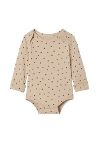 Long-sleeve beige onesie made of soft cotton, featuring navy polka dots, snap closure at the bottom, and folded cuffs.