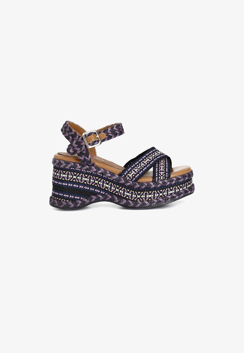 Wedge sandal featuring braided fabric in shades of purple and black, embellished with multi-colored patterns and an adjustable ankle strap.
