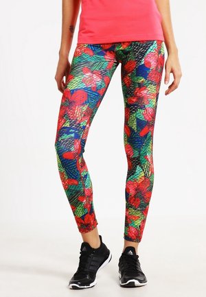 Kleurige leggings met een levendig bloemenpatroon in rood, groen en blauw, met een nauwsluitend ontwerp en een gladde textuur.
