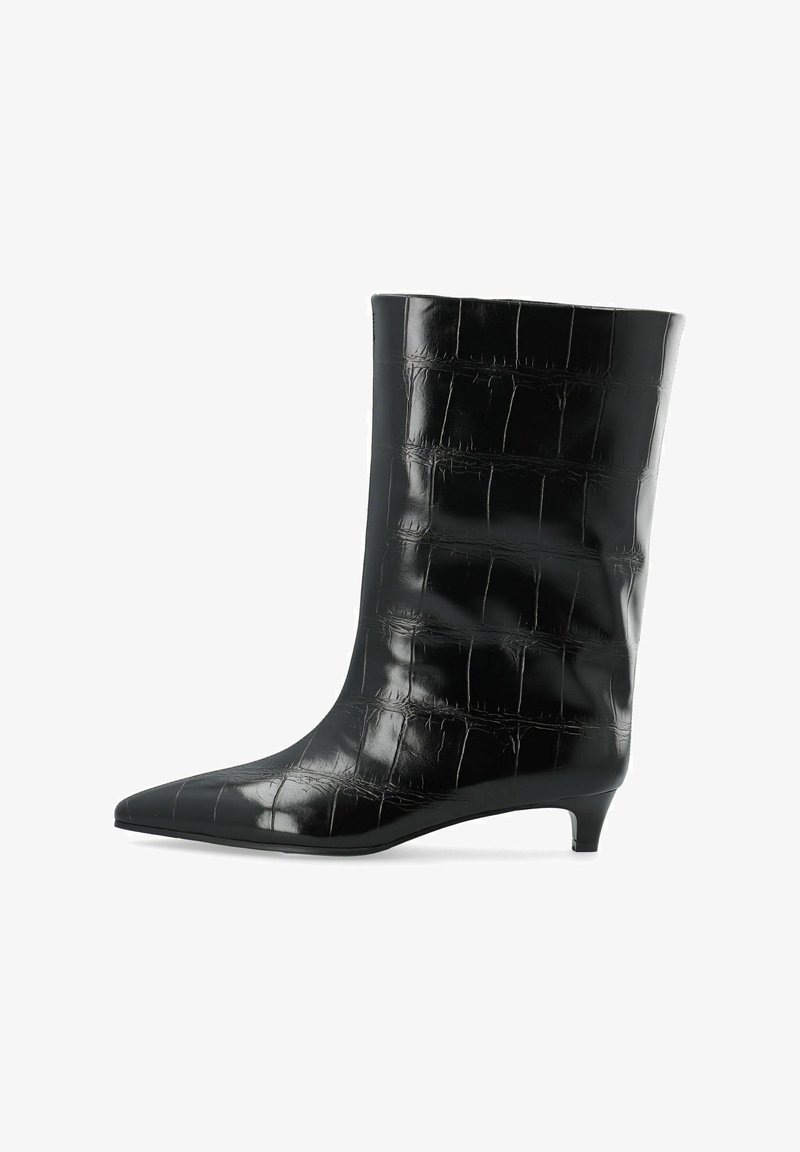 Botte en cuir noire mi-mollet avec texture crocodile, bout pointu et petit talon kitten sur fond blanc.