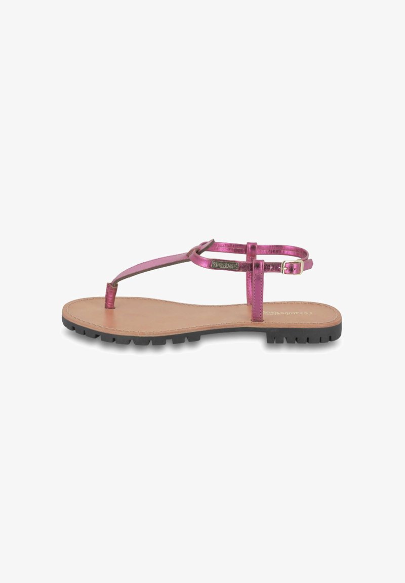Roze metallic teensandaal met een platte zool, minimaal bandjesontwerp en een gestructureerde zwarte rubberen buitenzool. Verstelbaar enkelbandje met gespsluiting.