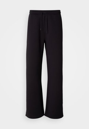Pantalones de chándal negros hechos de material suave, con cintura elástica ajustable, corte holgado y diseño de pierna recta. Estilo minimalista sin patrones.