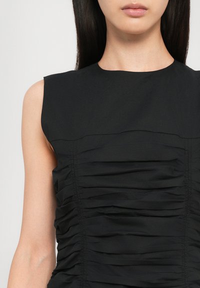 Black sleeveless top featuring ruched detailing along the sides and a smooth, structured neckline. Made of lightweight fabric.