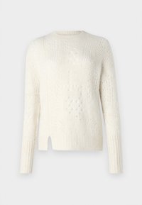 Ljuskrämfärgad tröja med strukturerad stickning, lös passform, ribbade ärmslut och nederkant samt sidoflikar för andningsförmåga.