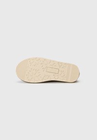 Schoenzool met beige rubberen loopvlak met geometrische patronen, het "JACK & JONES" logo, en maat nummer 41 op een witte achtergrond.