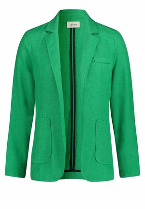 Blazer en lin vert avec une poche poitrine, deux poches avant et un col à revers. L'intérieur présente des rayures noires et blanches contrastantes.