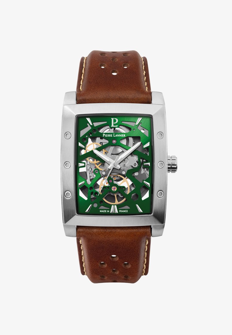 Quadratische Edelstahl-Uhr mit grünem Skelett-Zifferblatt, bronze Akzenten und einem braunen Lederarmband mit gesticktem Detail und Perforationen.