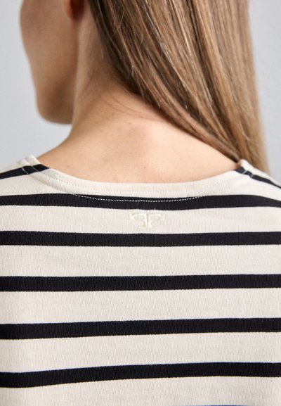 Striped crew-neck top featuring navy and off-white stripes, soft cotton material, and a small logo stitched at the back neckline.
